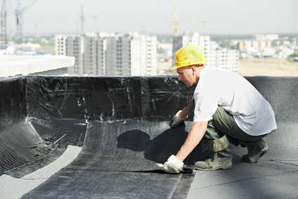 man working on a flat roof